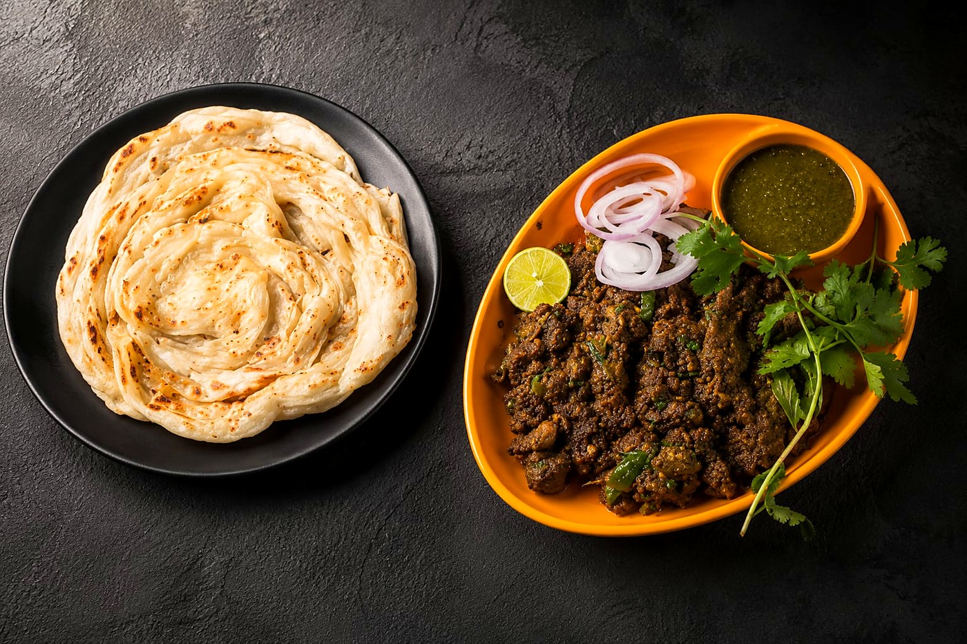 Rich Mughlai chicken curry in a copper handi